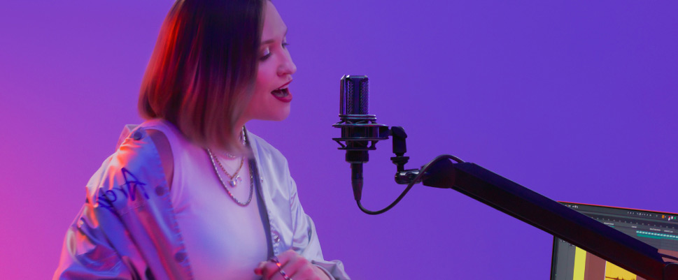 performer singing into a studio microphone