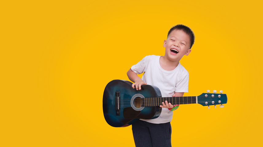 A child playing the Guitar happily