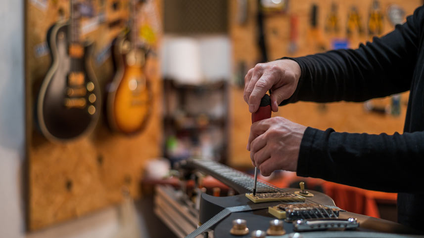 Guitar expert demonstrating in a music shop