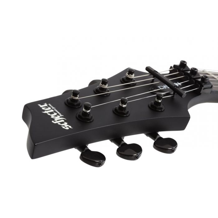Closeup of the headstock on a Schecter Damien-6 FR LH Electric Guitar, Satin Black