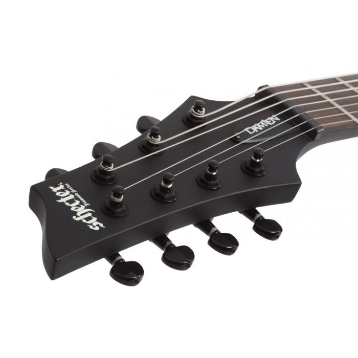 Front vie wof the headstock on a Schecter Damien-7 LH 7-String Electric Guitar, Satin Black