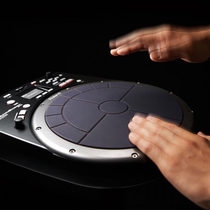 Person playing electronic drum pads