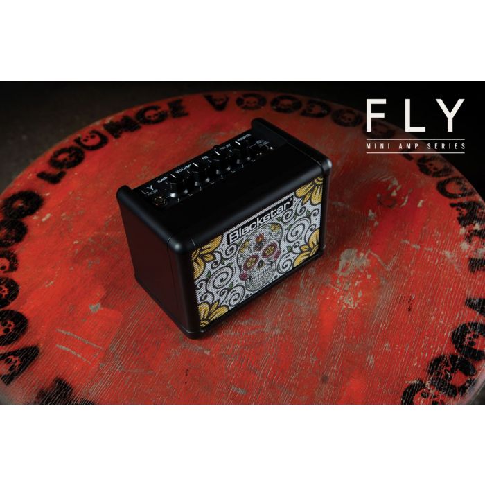 Blackstar Fly 3 Mini Amp with Sugar Skull Design On A Red Table