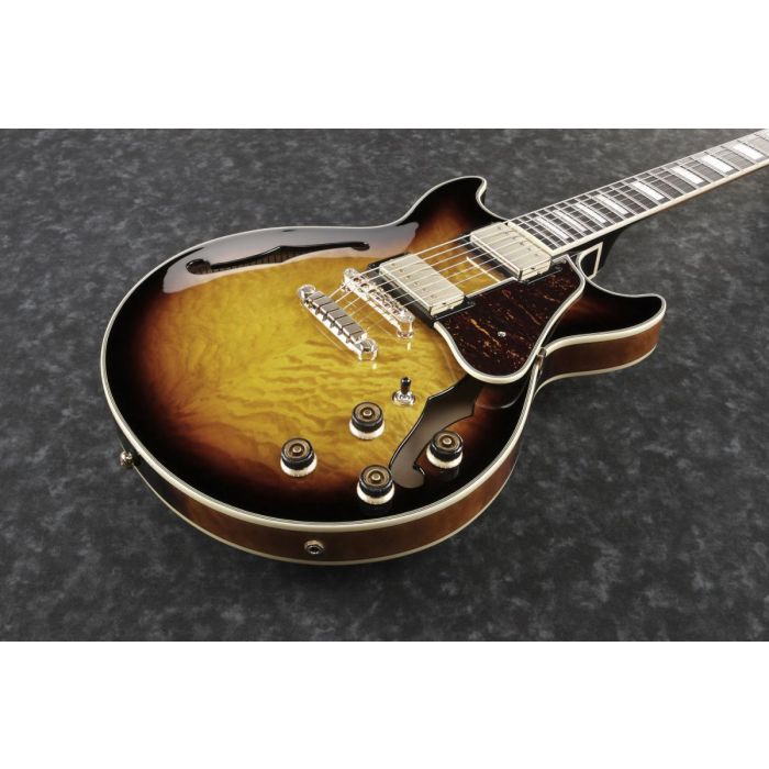 Closeup frontal view of an Ibanez AM93QM semi hollow guitar in Antique Yellow Sunburst
