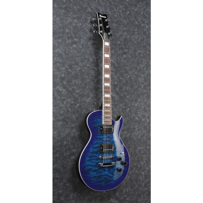 Front-angled view of a single cutaway Ibanez ART120QA electric guitar in trans blue burst