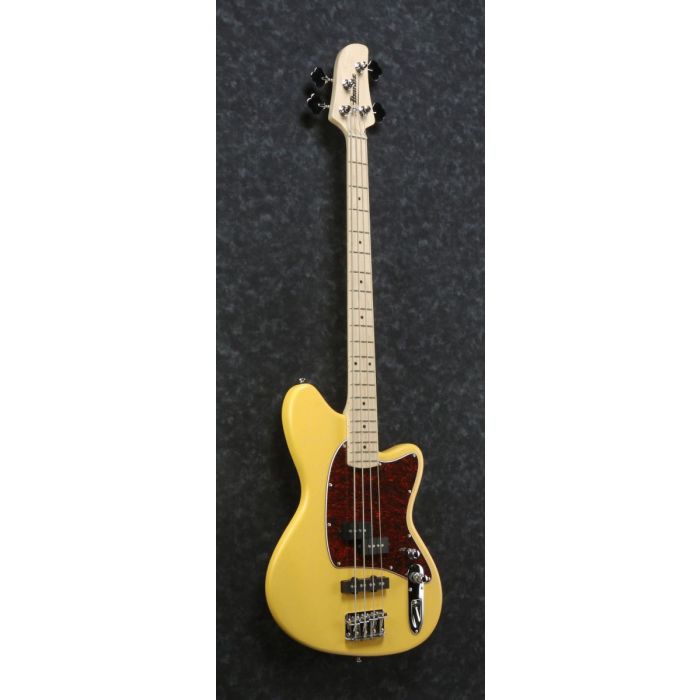 Front angled view of a Mustard Yellow flat Ibanez Talman TMB100M bass guitar