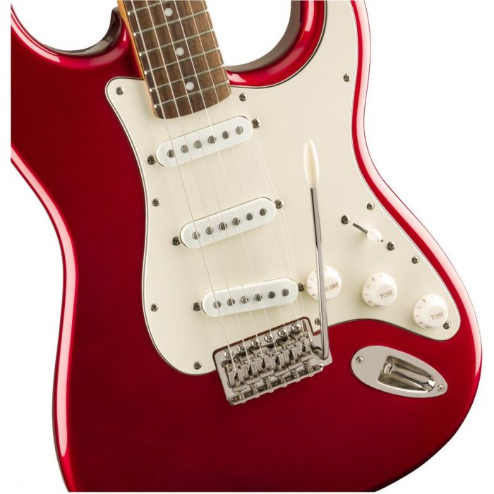 Closeup front view of a Squier Classic Vibe 60s Stratocaster Candy Apple Red