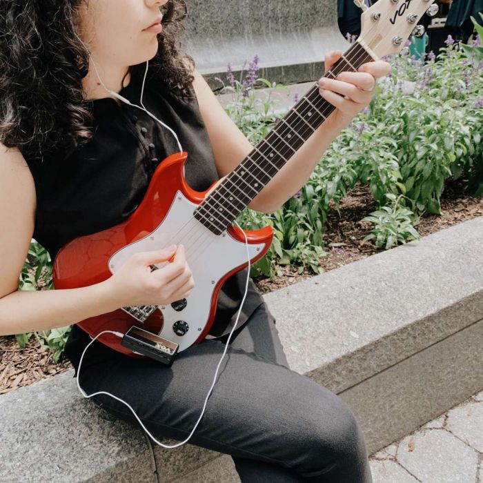 Woman Playing Vox SDC-1 Mini Electric Guitar with an AmPlug Headphone Amplifier