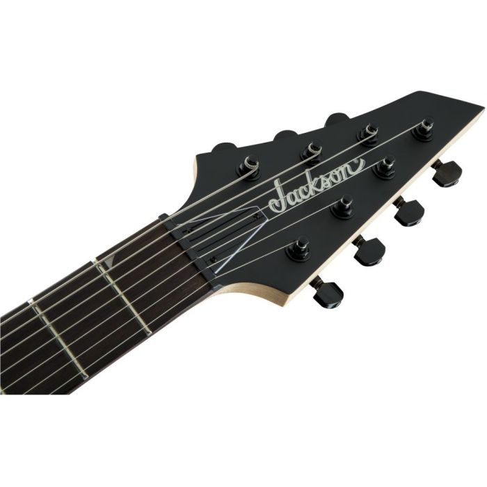 Closeup of the AT-1 headstock on a 7-stringed Jackson JS-series Dinky guitar