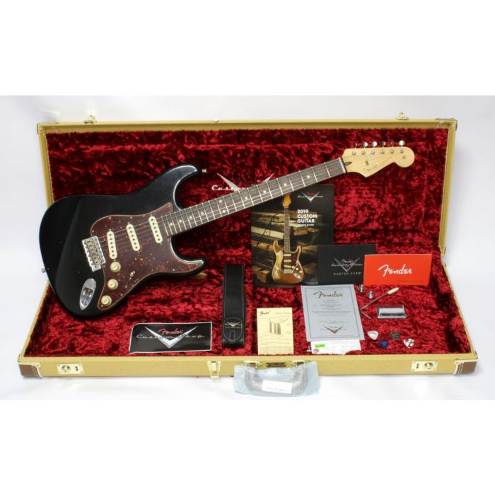 Full view of a Fender Custom Shop Strat and accessories in its case, black finish