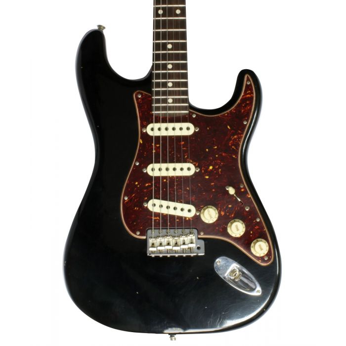 Closeup view of the body on a Fender Custom Shop Postmodern Strat with a Black Journeyman Relic finish