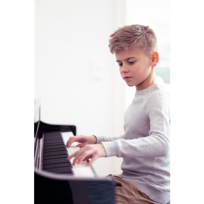 Child Playing Yamaha CLP-735 Digital Piano White